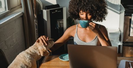 self-employed woman and her dog at a laptop