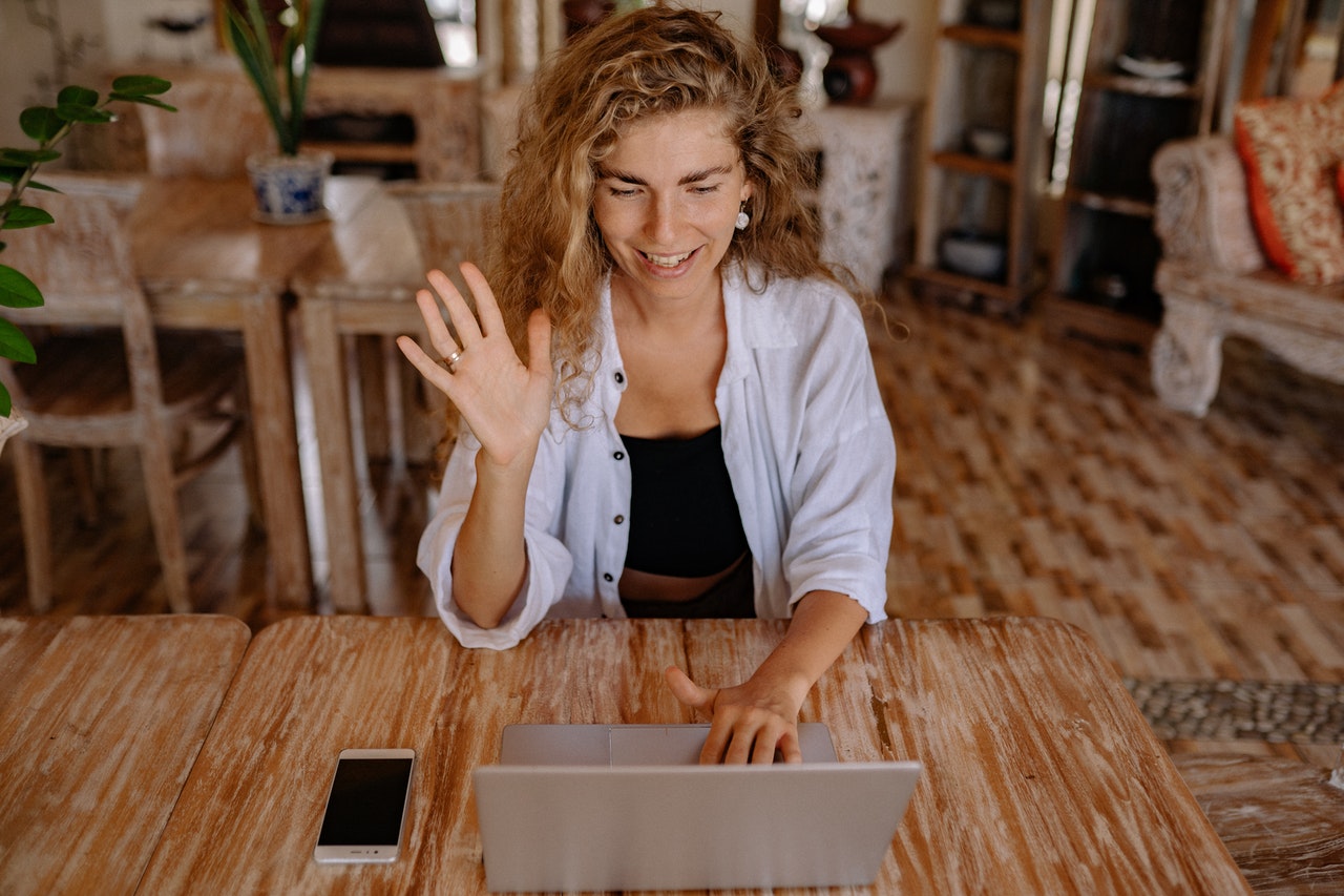 woman smiles at her laptop