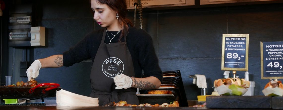 Woman working the till at a cafe